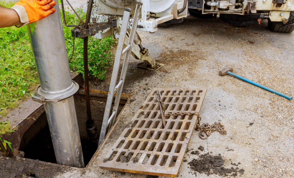 Yard drain grate beside a downspout
